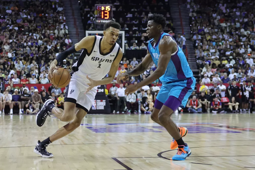 LAS VEGAS, NEVADA - JULY 07: Victor Wembanyama #1 of the San Antonio Spurs drives to the basket against James Nnaji #46 of the Charlotte Hornets during the first quarter at the Thomas & Mack Center on July 07, 2023 in Las Vegas, Nevada.