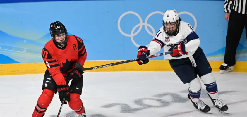 BEIJING, CHINA - FEBRUARY 17: Blayre Turnbull of Canada and Abby Roque of USA battle for the puck at the women's ice hockey gold medal match between Canada and USA during the Beijing 2022 Winter Olympics at National Indoor Stadium on February 17, 2022 in Beijing, China