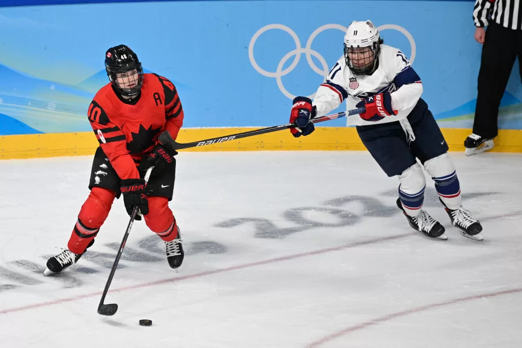 BEIJING, CHINA - FEBRUARY 17: Blayre Turnbull of Canada and Abby Roque of USA battle for the puck at the women's ice hockey gold medal match between Canada and USA during the Beijing 2022 Winter Olympics at National Indoor Stadium on February 17, 2022 in Beijing, China