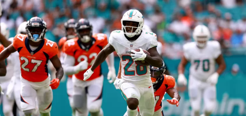 MIAMI GARDENS, FLORIDA - SEPTEMBER 24: De'Von Achane #28 of the Miami Dolphins rushes for a touchdown against the Denver Broncos during the fourth quarter at Hard Rock Stadium on September 24, 2023 in Miami Gardens, Florida