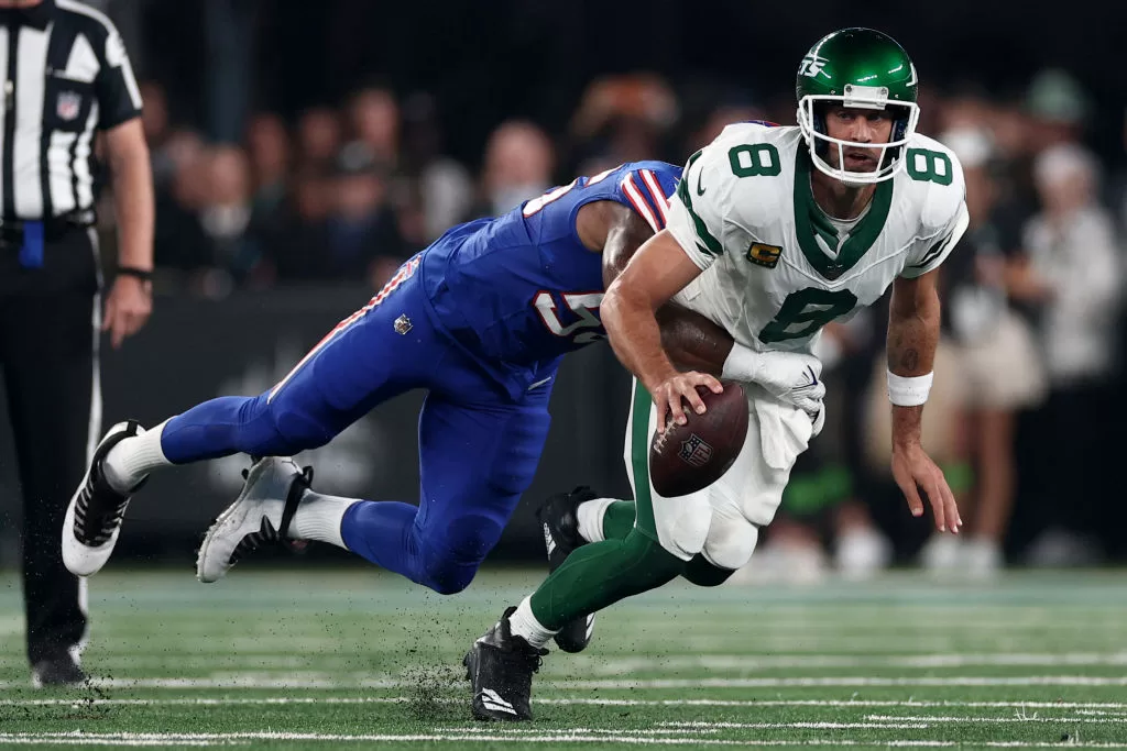 EAST RUTHERFORD, NEW JERSEY - SEPTEMBER 11: Quarterback Aaron Rodgers #8 of the New York Jets sacked by defensive end Leonard Floyd #56 of the Buffalo Bills during the first quarter of the NFL game at MetLife Stadium on September 11, 2023 in East Rutherford, New Jersey