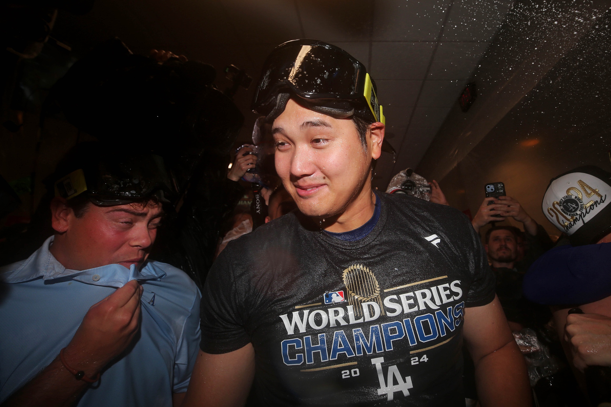 Oct 31, 2024; New York, New York, USA; Los Angeles Dodgers two-way player Shohei Ohtani (17) celebrates in the locker room after the Los Angeles Dodgers beat the New York Yankees in game four to win the 2024 MLB World Series at Yankee Stadium.