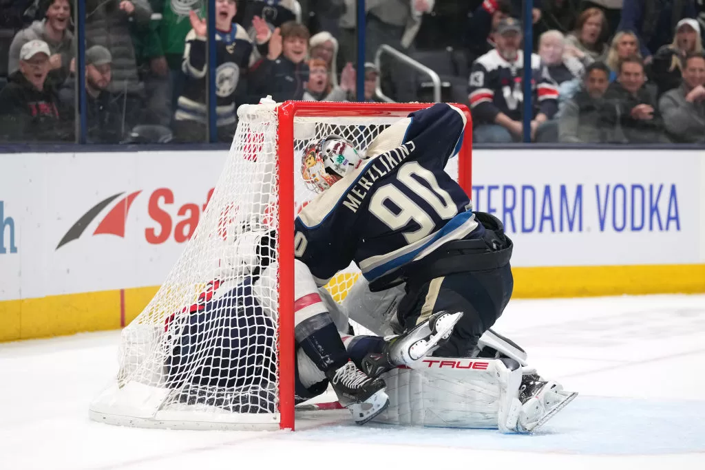 COLUMBUS, OH - DECEMBER 21: Elvis Merzlikins #90 of the Columbus Blue Jackets fights Tom Wilson #43 of the Washington Capitals in a goal during overtime at Nationwide Arena in Columbus, Ohio on December 21, 2023.