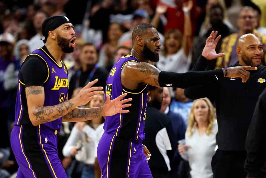 MINNEAPOLIS, MINNESOTA - DECEMBER 30: LeBron James #23 (C) and Anthony Davis #3 of the Los Angeles Lakers react as it's announced James' basket is upheld as a two-point basket after review against the Minnesota Timberwolves in the fourth quarter at Target Center on December 30, 2023 in Minneapolis, Minnesota. The Timberwolves defeated the Lakers 108-106