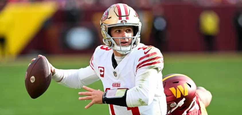 LANDOVER, MARYLAND - DECEMBER 31: Brock Purdy #13 of the San Francisco 49ers looks to pass under pressure during the second quarter of a game against the Washington Commanders at FedExField on December 31, 2023 in Landover, Maryland.