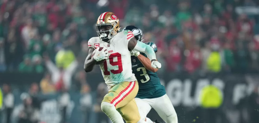 PHILADELPHIA, PENNSYLVANIA - DECEMBER 3: Deebo Samuel #19 of the San Francisco 49ers runs past Christian Elliss #53 of the Philadelphia Eagles at Lincoln Financial Field on December 3, 2023 in Philadelphia, Pennsylvania.