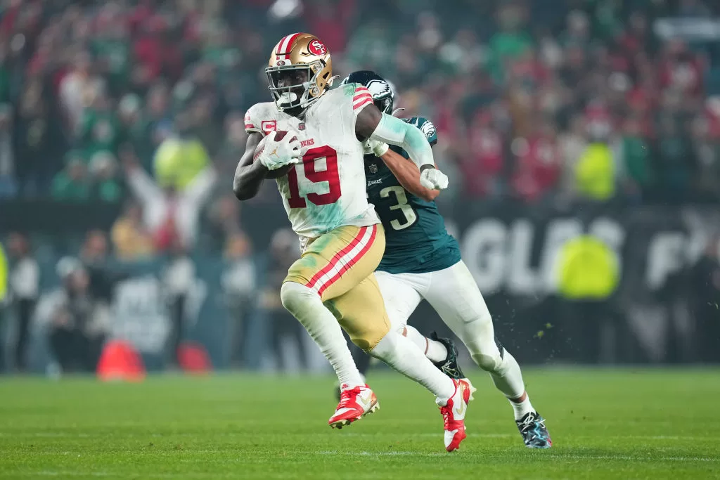 PHILADELPHIA, PENNSYLVANIA - DECEMBER 3: Deebo Samuel #19 of the San Francisco 49ers runs past Christian Elliss #53 of the Philadelphia Eagles at Lincoln Financial Field on December 3, 2023 in Philadelphia, Pennsylvania.