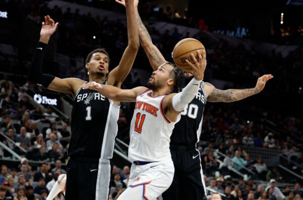 SAN ANTONIO, TX - MARCH 29: Jalen Brunson #11 of the New York Knicks drives on Victor Wembanyama #1 of the San Antonio Spurs during the second half at Frost Bank Center on March 29, 2024 in San Antonio, Texas.