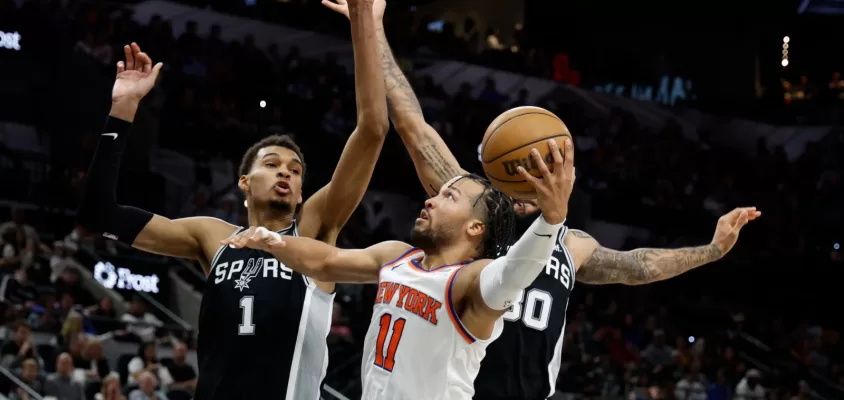 SAN ANTONIO, TX - MARCH 29: Jalen Brunson #11 of the New York Knicks drives on Victor Wembanyama #1 of the San Antonio Spurs during the second half at Frost Bank Center on March 29, 2024 in San Antonio, Texas.