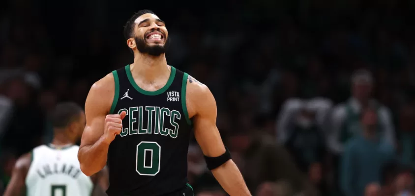 BOSTON, MASSACHUSETTS - NOVEMBER 22: Jayson Tatum #0 of the Boston Celtics reacts after Jrue Holiday #4 missed a shot against the Milwaukee Bucks during the second quarter at TD Garden on November 22, 2023 in Boston, Massachusetts.