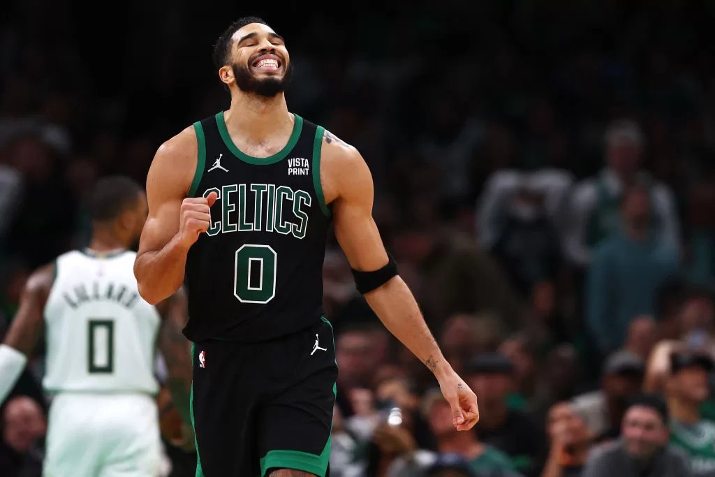 BOSTON, MASSACHUSETTS - NOVEMBER 22: Jayson Tatum #0 of the Boston Celtics reacts after Jrue Holiday #4 missed a shot against the Milwaukee Bucks during the second quarter at TD Garden on November 22, 2023 in Boston, Massachusetts.