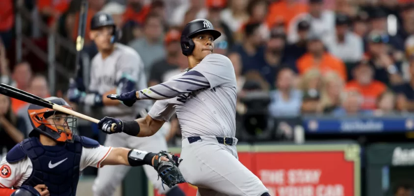 HOUSTON, TEXAS - MARCH 28: Juan Soto #22 of the New York Yankees hits an RBI single in the fifth inning against the Houston Astros on Opening Day at Minute Maid Park on March 28, 2024 in Houston, Texas.