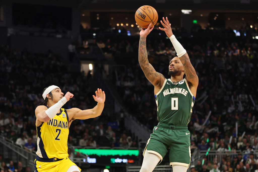 MILWAUKEE, WISCONSIN - APRIL 21: Damian Lillard #0 of the Milwaukee Bucks shoots over Andrew Nembhard #2 of the Indiana Pacers during the second half of game one of the Eastern Conference First Round Playoffs at Fiserv Forum on April 21, 2024 in Milwaukee, Wisconsin.