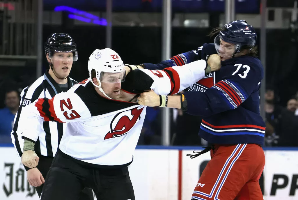 NEW YORK, NEW YORK - APRIL 03: Kurtis MacDermid #23 of the New Jersey Devils fights with Matt Rempe #73 of the New York Rangers during the first period at Madison Square Garden on April 03, 2024 in New York City