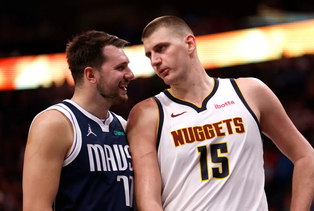 DALLAS, TX - MARCH 17: Luka Doncic #77 of the Dallas Mavericks and Nikola Jokic #15 of the Denver Nuggets talk during a beak in the action in the second half at American Airlines Center on March 17, 2024 in Dallas, Texas.