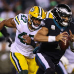 PHILADELPHIA, PA - NOVEMBER 27: Jalen Hurts #1 of the Philadelphia Eagles scrambles as Justin Hollins #47 of the Green Bay Packers defends during the first half at Lincoln Financial Field on November 27, 2022 in Philadelphia, Pennsylvania