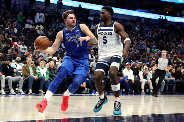 DALLAS, TEXAS - DECEMBER 14: Luka Doncic #77 of the Dallas Mavericks drives to the basket against Anthony Edwards #5 of the Minnesota Timberwolves in the second half at American Airlines Center on December 14, 2023 in Dallas, Texas. NOTE TO USER: User expressly acknowledges and agrees that, by downloading and or using this photograph, User is consenting to the terms and conditions of the Getty Images License Agreement.