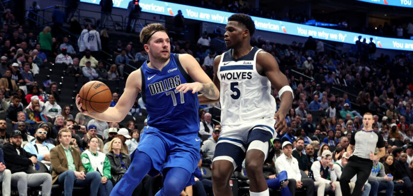 DALLAS, TEXAS - DECEMBER 14: Luka Doncic #77 of the Dallas Mavericks drives to the basket against Anthony Edwards #5 of the Minnesota Timberwolves in the second half at American Airlines Center on December 14, 2023 in Dallas, Texas. NOTE TO USER: User expressly acknowledges and agrees that, by downloading and or using this photograph, User is consenting to the terms and conditions of the Getty Images License Agreement.