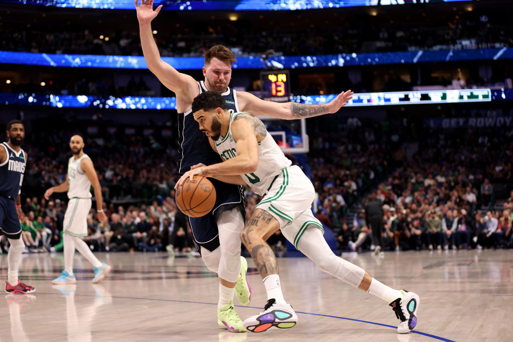 DALLAS, TEXAS - JANUARY 22: Jayson Tatum #0 of the Boston Celtics goes to the basket against Luka Doncic #77 of the Dallas Mavericks in the second half at American Airlines Center on January 22, 2024 in Dallas, Texas. NOTE TO USER: User expressly acknowledges and agrees that, by downloading and or using this photograph, User is consenting to the terms and conditions of the Getty Images License Agreement.