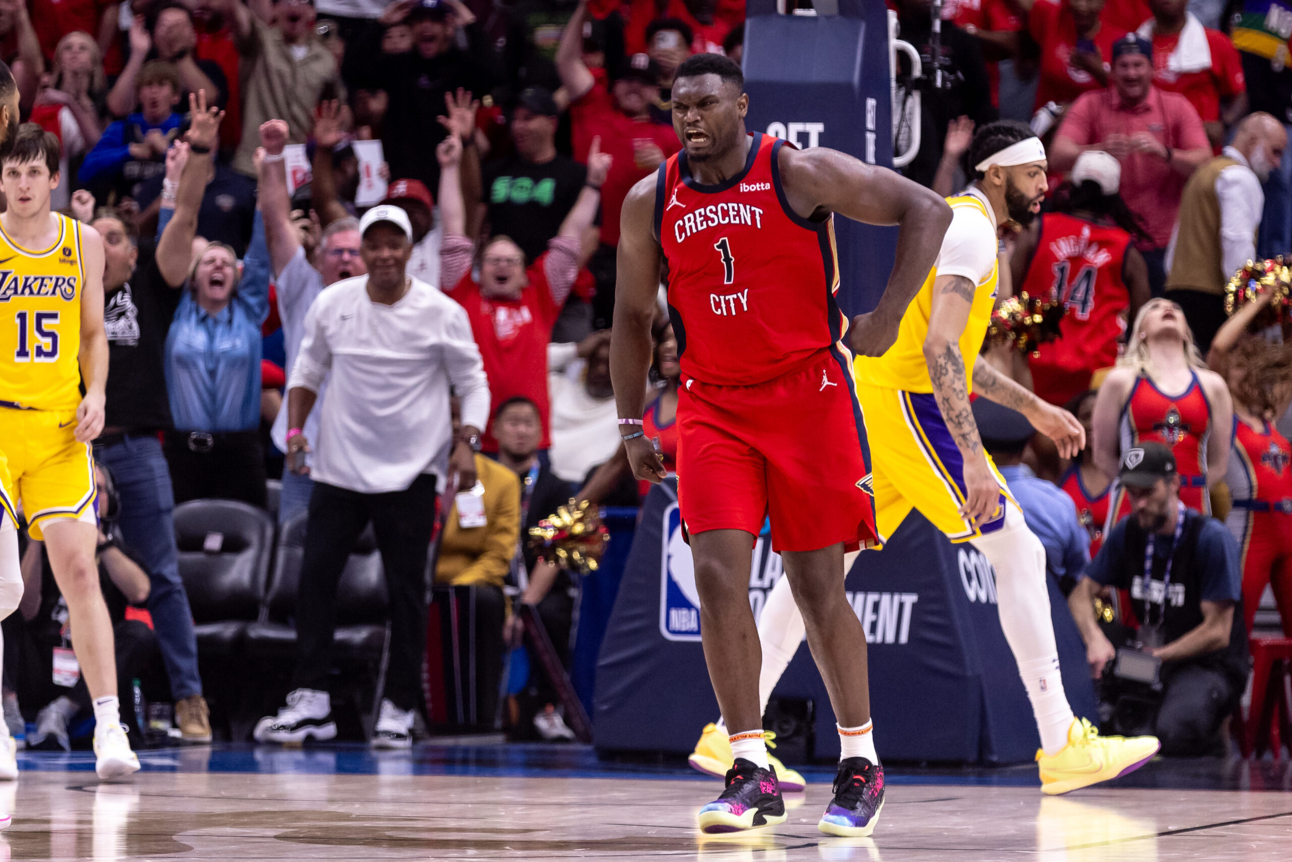 Apr 16, 2024; New Orleans, Louisiana, USA; New Orleans Pelicans forward Zion Williamson (1) reacts to making a basket against Los Angeles Lakers forward Anthony Davis (3) during the second half of a play-in game of the 2024 NBA playoffs at Smoothie King Center.