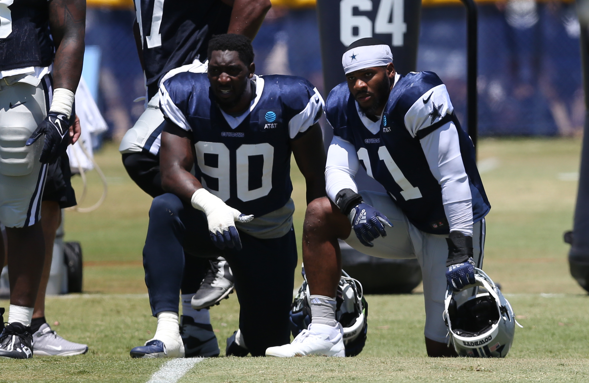 Jul 30, 2024; Oxnard, CA, USA; Dallas Cowboys defensive end DeMarcus Lawrence (90) and linebacker Micah Parsons (11) during training camp at the River Ridge Playing Fields in Oxnard, California.