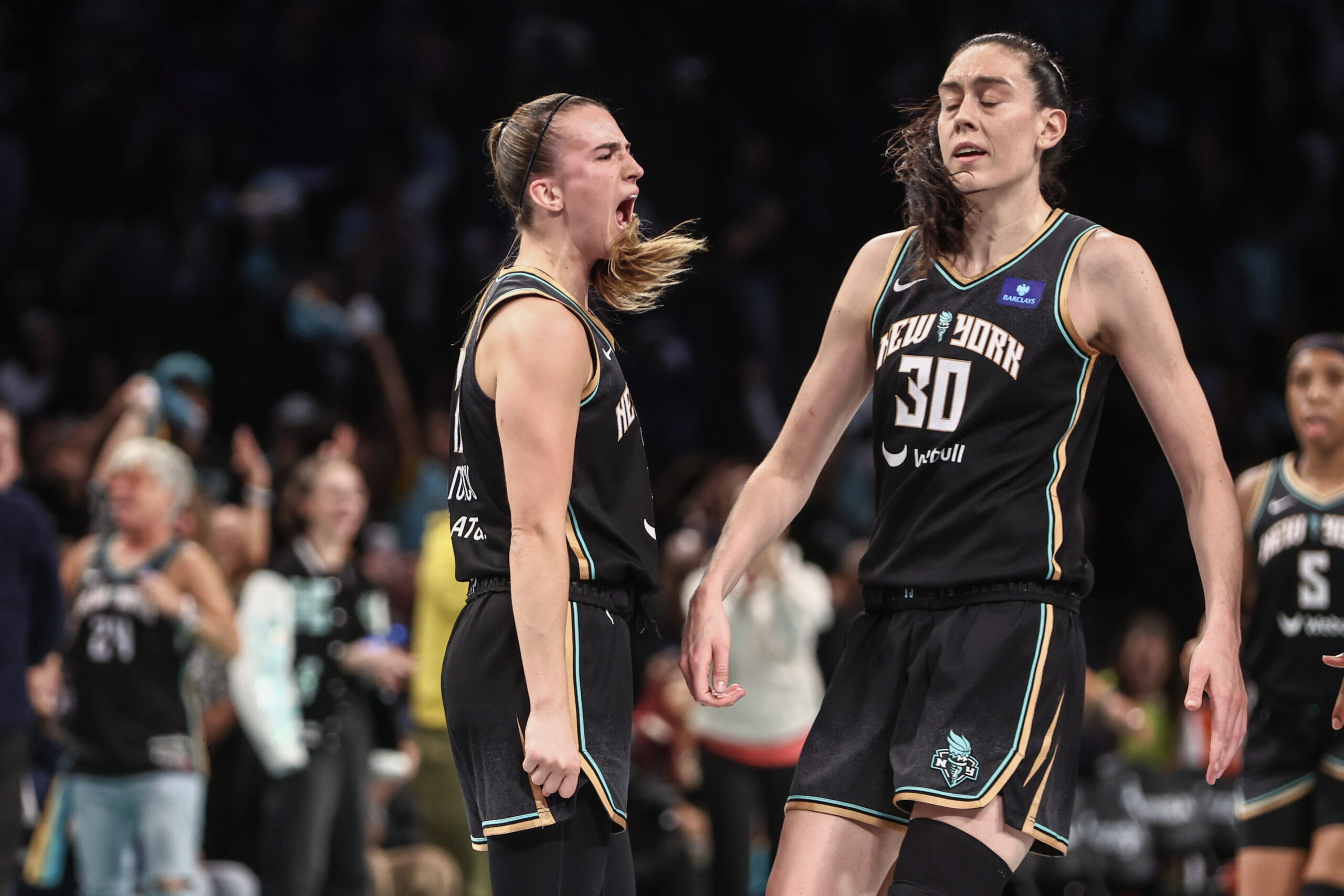 Sep 24, 2024; Brooklyn, New York, USA; New York Liberty guard Sabrina Ionescu (20) celebrates with forward Breanna Stewart (30) during game two of the first round of the 2024 WNBA Playoffs against the Atlanta Dream at Barclays Center.