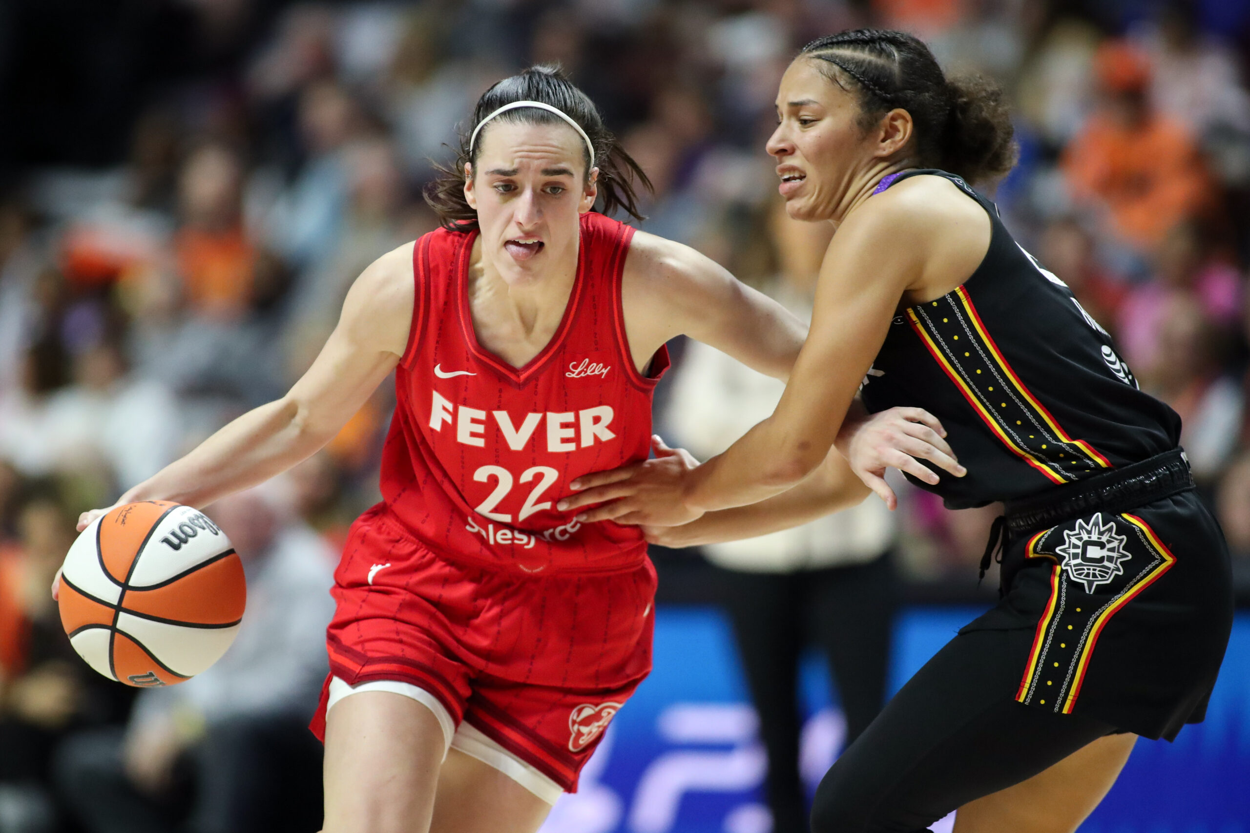 Sep 25, 2024; Uncasville, Connecticut, USA; Indiana Fever guard Caitlin Clark (22) dribbles the ball during the first half against the Connecticut Sun during game two of the first round of the 2024 WNBA Playoffs at Mohegan Sun Arena. Mandatory Credit: Paul Rutherford-Imagn Images