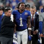 Sep 26, 2024; East Rutherford, New Jersey, USA; New York Giants wide receiver Malik Nabers (1) is helped off the field after an injury during the fourth quarter against the Dallas Cowboys at MetLife Stadium. Mandatory Credit: Brad Penner-Imagn Images