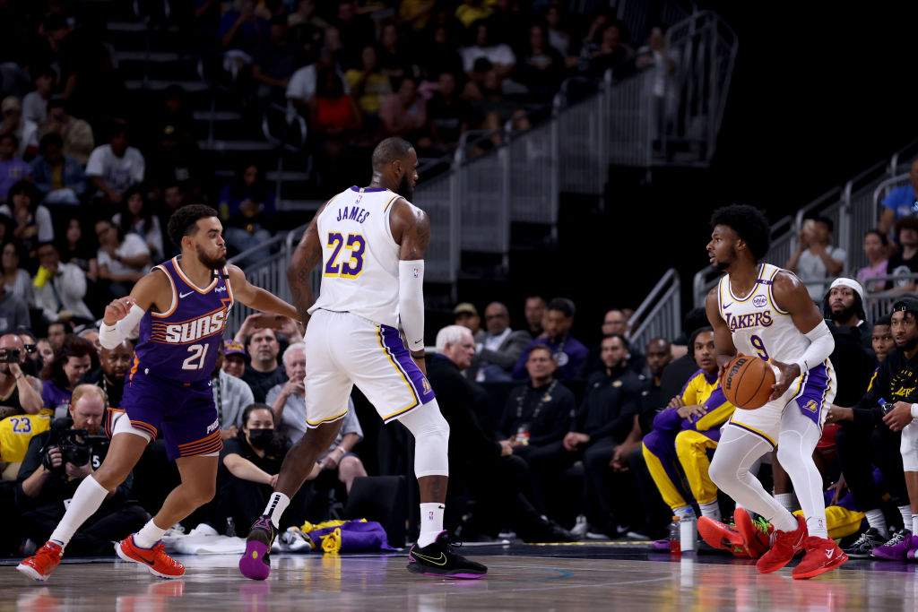 PALM SPRINGS, CALIFORNIA - OCTOBER 06: LeBron James #23 of the Los Angeles Lakers sets a screen for Bronny James #9 against Tyus Jones #21 of the Phoenix Suns during the second quarter at Acrisure Arena on October 06, 2024 in Palm Springs, California. NOTE TO USER: User expressly acknowledges and agrees that, by downloading and/or using this photograph, user is consenting to the terms and conditions of the Getty Images License Agreement. (Photo by Katelyn Mulcahy/Getty Images)