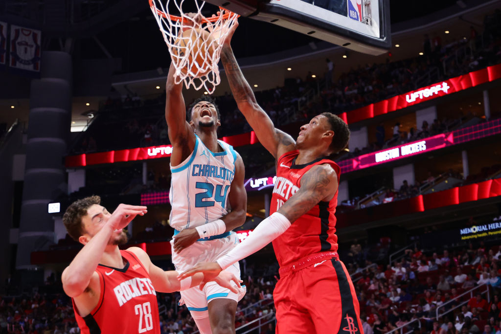 HOUSTON, TEXAS - OCTOBER 23: Brandon Miller #24 of the Charlotte Hornets slam dunks the ball over Alperen Sengun #28 of the Houston Rockets and Jabari Smith Jr. #10 during the first half at Toyota Center on October 23, 2024 in Houston, Texas. NOTE TO USER: User expressly acknowledges and agrees that, by downloading and or using this photograph, User is consenting to the terms and conditions of the Getty Images License Agreement. (Photo by Alex Slitz/Getty Images)