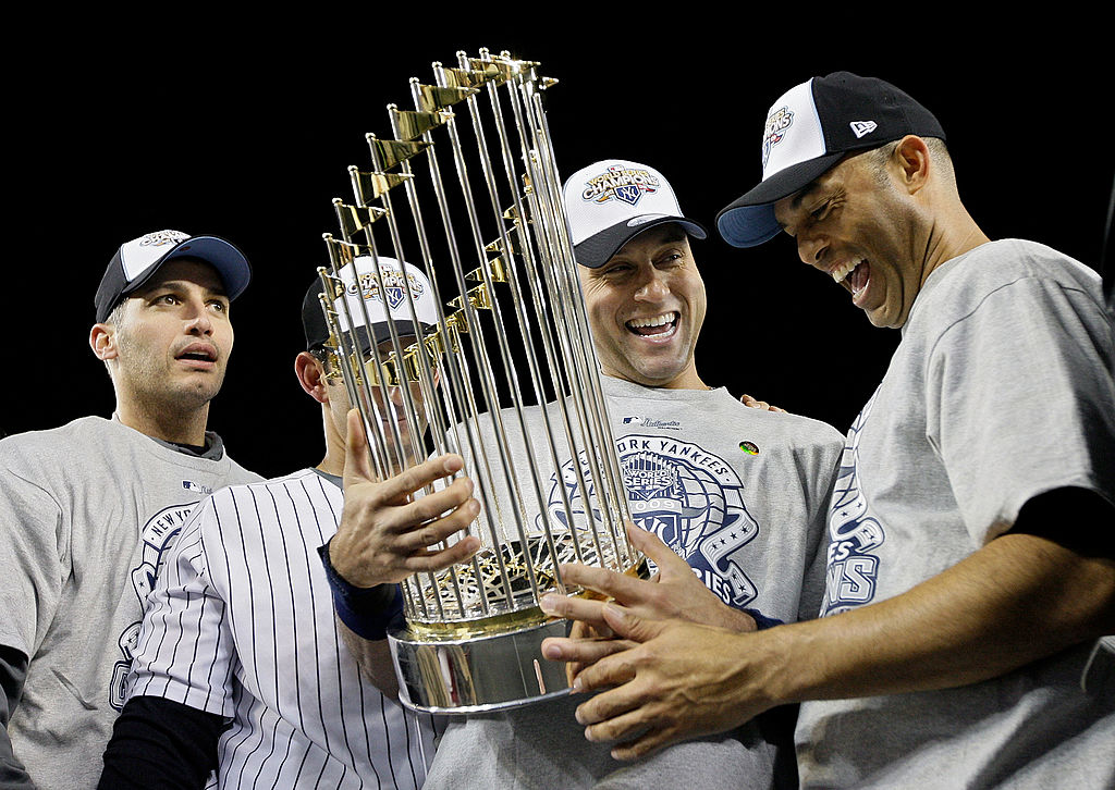 NEW YORK - NOVEMBER 04: (L-R) Andy Pettitte #46, Jorge Posada #20, Derek Jeter #2 and Mariano Rivera #42 of the New York Yankees celebrate with the trophy after their 7-3 win against the Philadelphia Phillies in Game Six of the 2009 MLB World Series at Yankee Stadium on November 4, 2009 in the Bronx borough of New York City. (Photo by Pool/Getty Images)