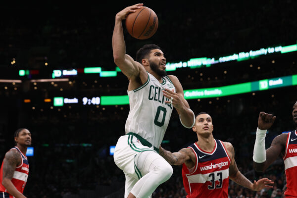 Oct 27, 2021; Boston, Massachusetts, USA; Boston Celtics forward Jayson Tatum (0) goes to the basket past Washington Wizards forward Kyle Kuzma (33) during the second half at TD Garden.