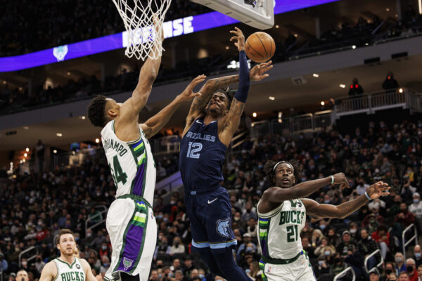 Jan 19, 2022; Milwaukee, Wisconsin, USA; Memphis Grizzlies guard Ja Morant (12) loses the ball under pressure from Milwaukee Bucks forward Giannis Antetokounmpo (34) during the second quarter at Fiserv Forum.