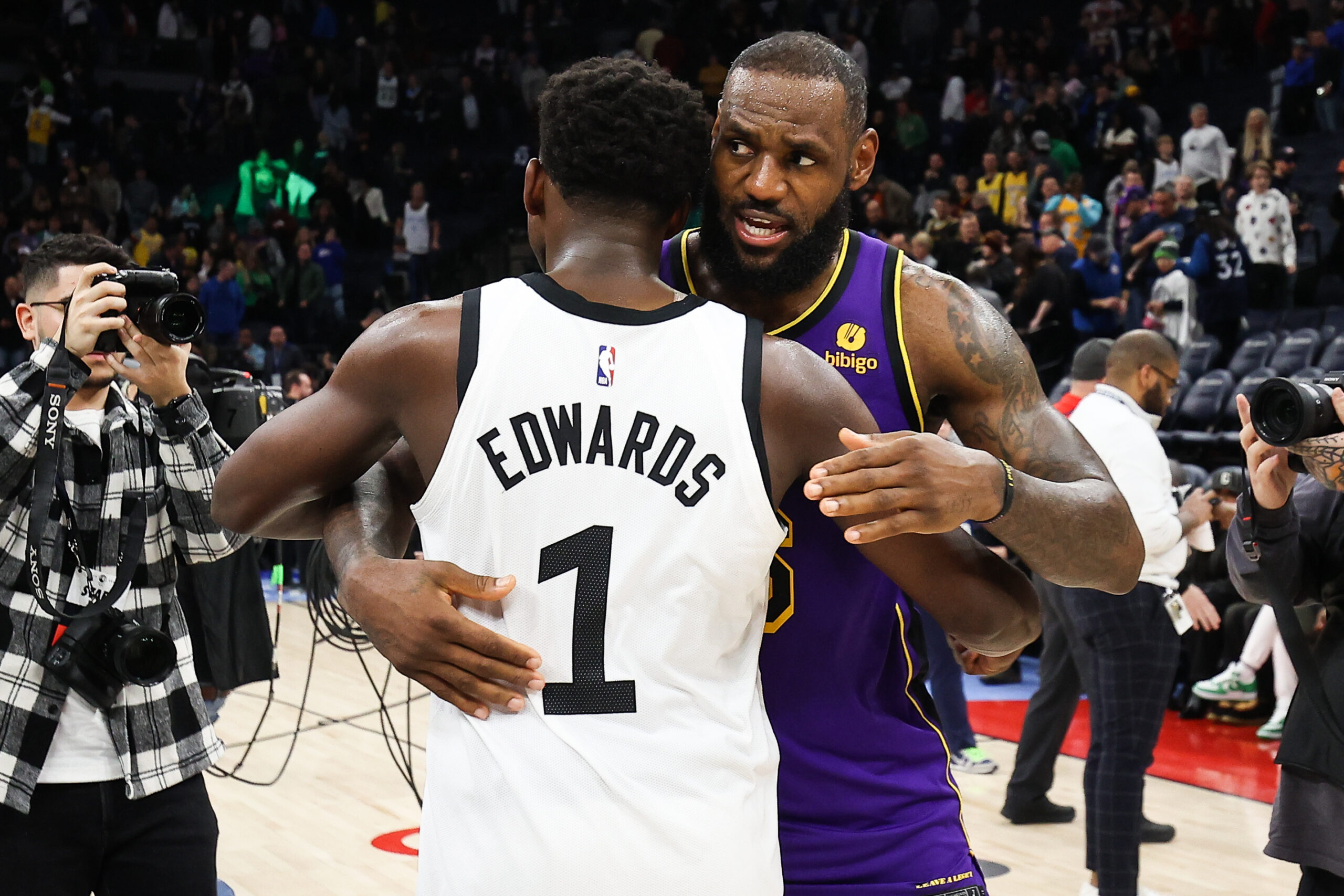 Mar 31, 2023; Minneapolis, Minnesota, USA; Minnesota Timberwolves guard Anthony Edwards (1) and Los Angeles Lakers forward LeBron James (6) hug after the game at Target Center.