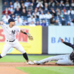 May 1, 2023; Bronx, New York, USA; New York Yankees shortstop Anthony Volpe (11) throws past Cleveland Guardians shortstop Amed Rosario (1) attempting to complete a double play in the first inning at Yankee Stadium. Mandatory Credit: Wendell Cruz-USA TODAY Sports