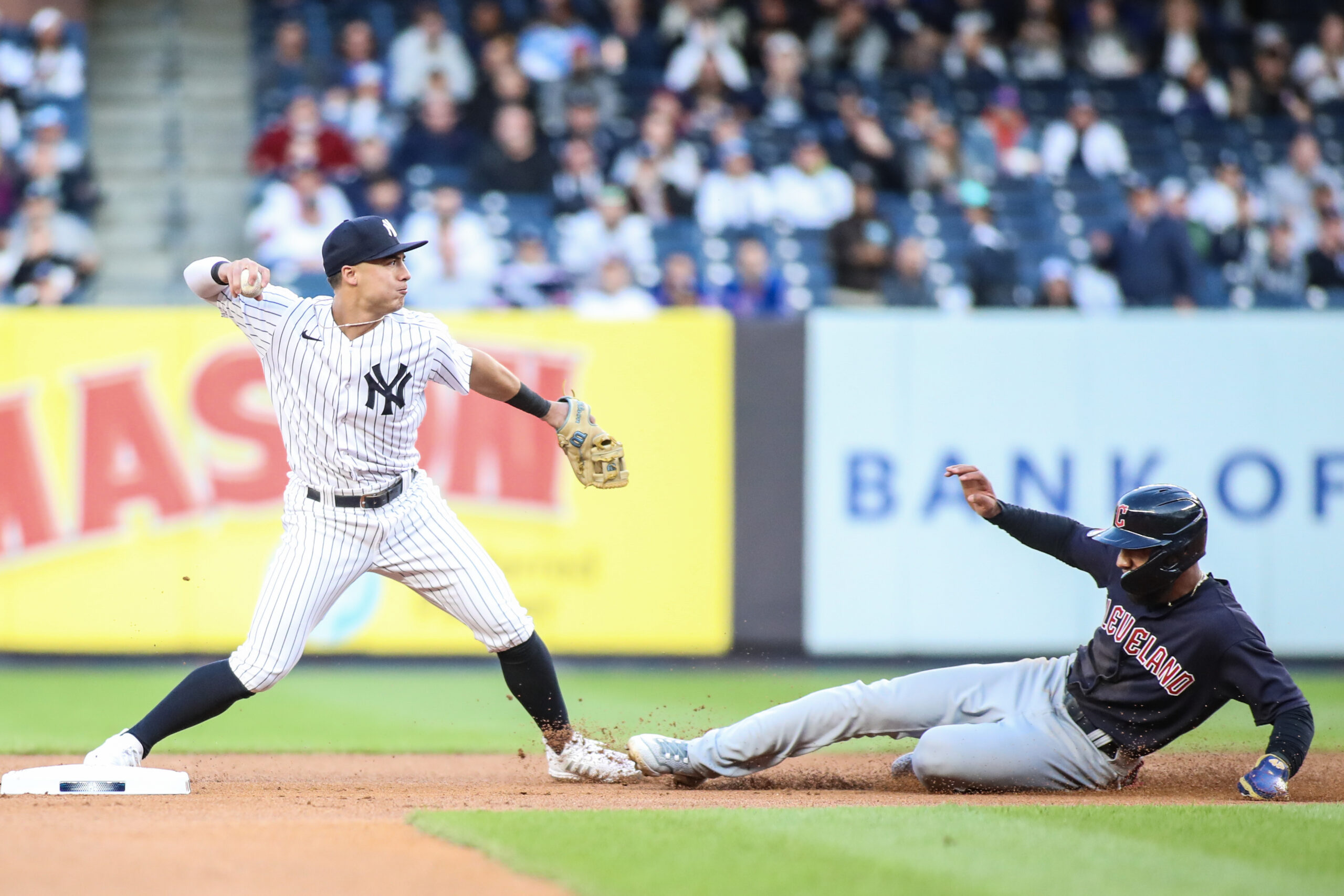 May 1, 2023; Bronx, New York, USA; New York Yankees shortstop Anthony Volpe (11) throws past Cleveland Guardians shortstop Amed Rosario (1) attempting to complete a double play in the first inning at Yankee Stadium. Mandatory Credit: Wendell Cruz-USA TODAY Sports