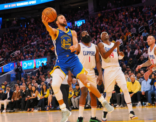 Nov 30, 2023; San Francisco, California, USA; NBA; Golden State Warriors guard Stephen Curry (30) scores against Los Angeles Clippers guard James Harden (1), guard Terance Mann (14) during the fourth quarter at Chase Center.