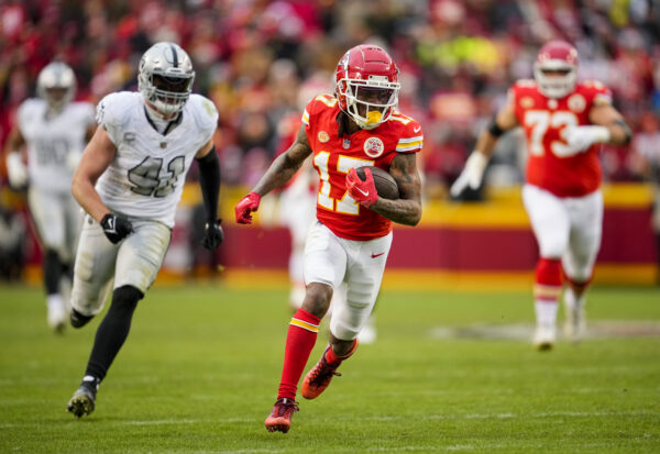 Dec 25, 2023; Kansas City, Missouri, USA; NFL; Kansas City Chiefs wide receiver Richie James (17) runs with the ball past Las Vegas Raiders linebacker Robert Spillane (41) during the second half at GEHA Field at Arrowhead Stadium.