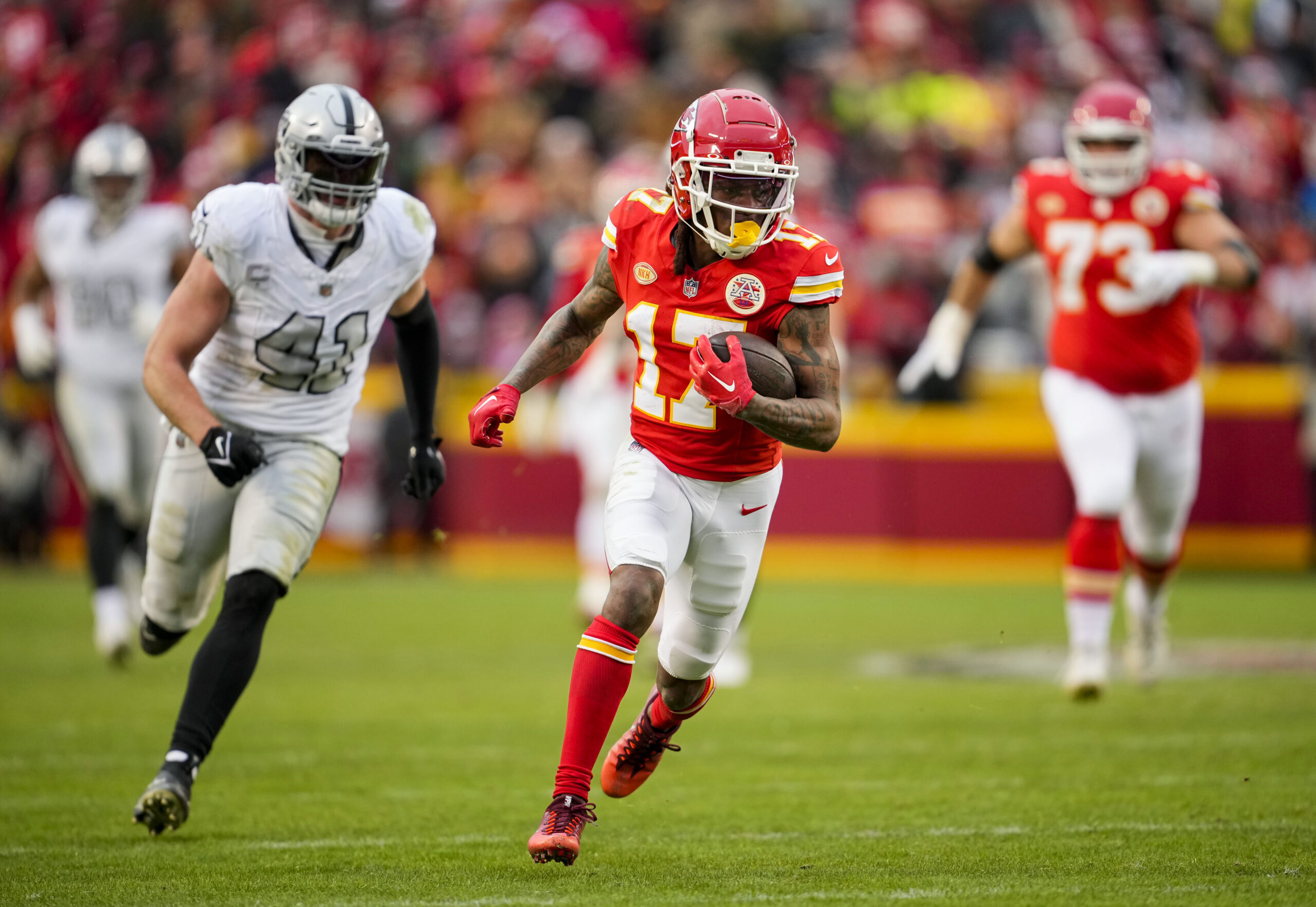 Dec 25, 2023; Kansas City, Missouri, USA; NFL; Kansas City Chiefs wide receiver Richie James (17) runs with the ball past Las Vegas Raiders linebacker Robert Spillane (41) during the second half at GEHA Field at Arrowhead Stadium.