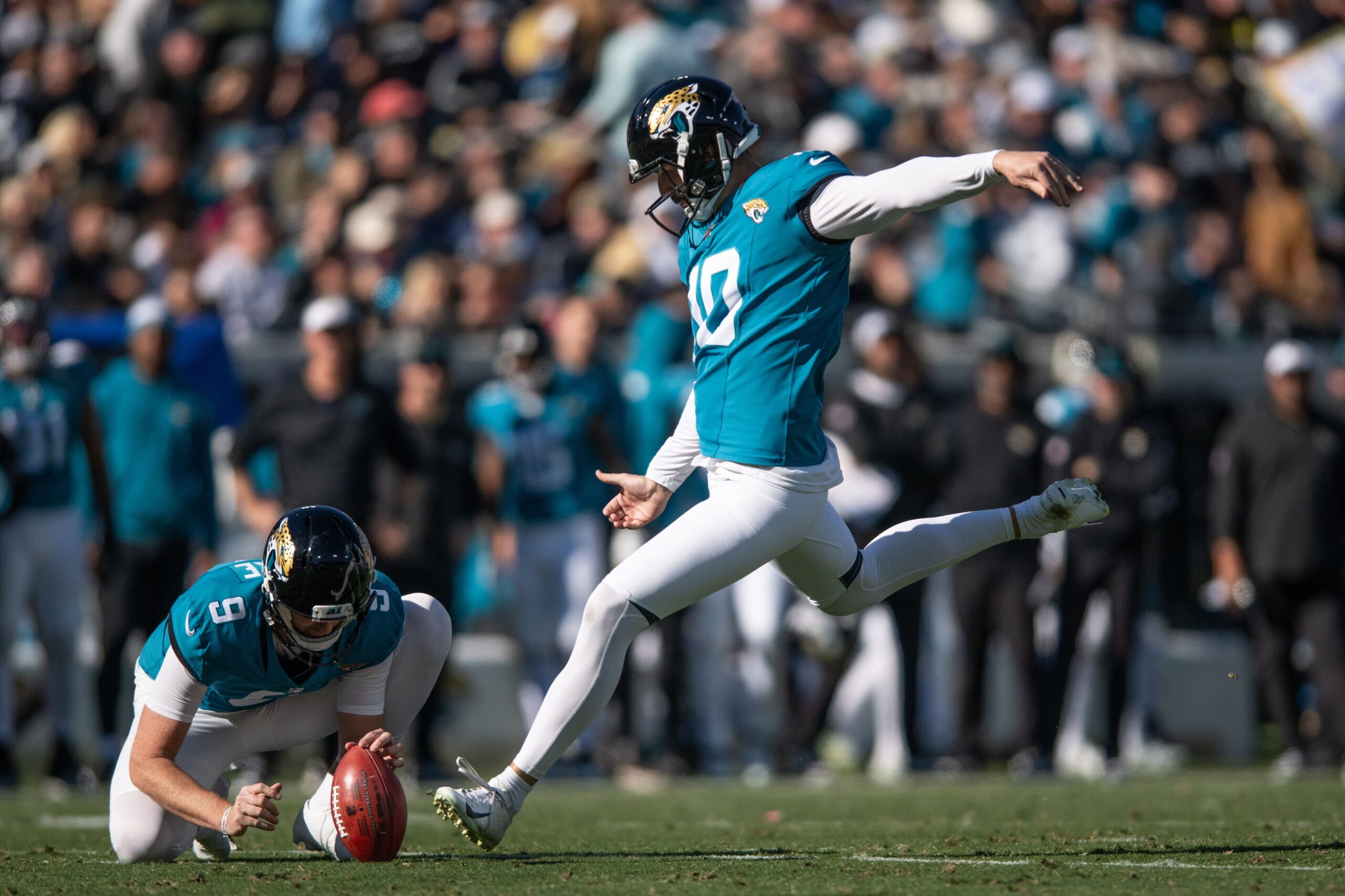 Dec 31, 2023; Jacksonville, Florida, USA; Jacksonville Jaguars punter Logan Cooke (9) holds the ball andnkicker Brandon McManus (10) make the field goal against the Carolina Panthers in the second quarter at EverBank Stadium. Mandatory Credit: Jeremy Reper-USA TODAY Sports