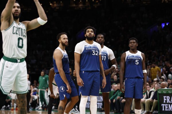 Jan 10, 2024; Boston, Massachusetts, USA; Minnesota Timberwolves forward Kyle Anderson (1), center Karl-Anthony Towns (32), center Naz Reid (11) and guard Anthony Edwards (5) watch as Boston Celtics forward Jayson Tatum (0) shoots a technical foul free throw during overtime of the Celtics 127-120 win at TD Garden.