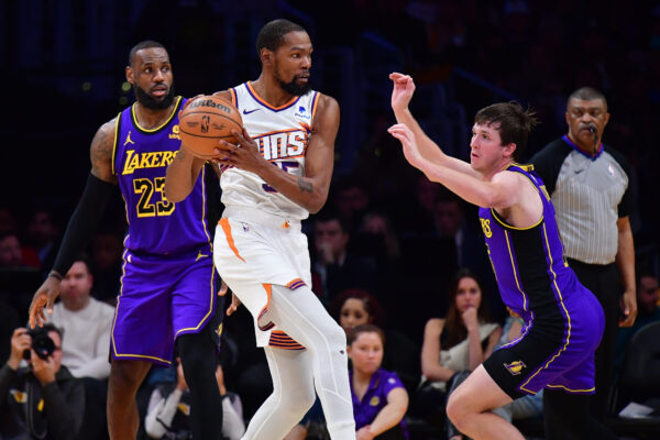 Jan 11, 2024; Los Angeles, California, USA; Phoenix Suns forward Kevin Durant (35) controls the ball against Los Angeles Lakers guard Austin Reaves (15) and forward LeBron James (23) during the second half at Crypto.com Arena.