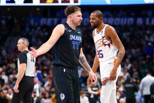 Jan 24, 2024; Dallas, Texas, USA; Phoenix Suns forward Kevin Durant (35) laughs in front of Dallas Mavericks guard Luka Doncic (77) during the third quarter against the Dallas Mavericks at American Airlines Center.