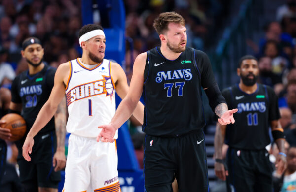 Feb 22, 2024; Dallas, Texas, USA; NBA; Dallas Mavericks guard Luka Doncic (77) reacts in front of Phoenix Suns guard Devin Booker (1) during the first half at American Airlines Center.