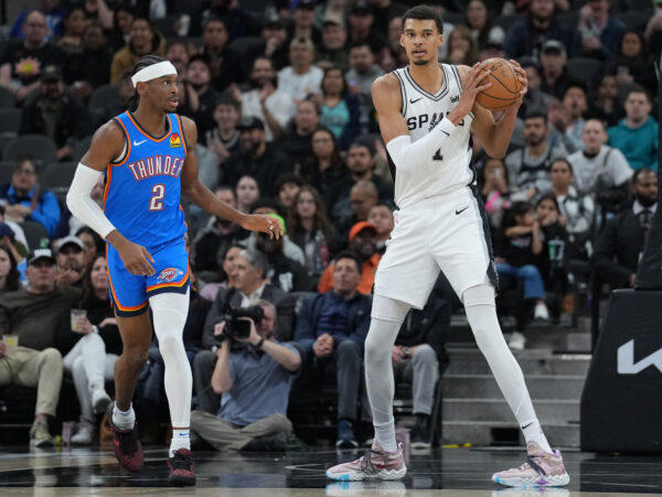 Feb 29, 2024; San Antonio, Texas, USA; San Antonio Spurs center Victor Wembanyama (1) looks down the court beside Oklahoma City Thunder guard Shai Gilgeous-Alexander (2) in the first half at Frost Bank Center.