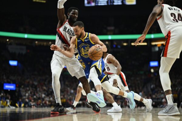 Apr 11, 2024; Portland, Oregon, USA; Golden State Warriors guard Stephen Curry (30) drives to the basket during the first half against Portland Trail Blazers center Deandre Ayton (2) at Moda Center.