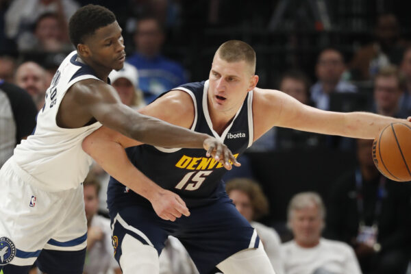 May 12, 2024; Minneapolis, Minnesota, USA; NBA; Denver Nuggets center Nikola Jokic (15) works around Minnesota Timberwolves guard Anthony Edwards (5) in the fourth quarter of game four of the second round for the 2024 NBA playoffs at Target Center.