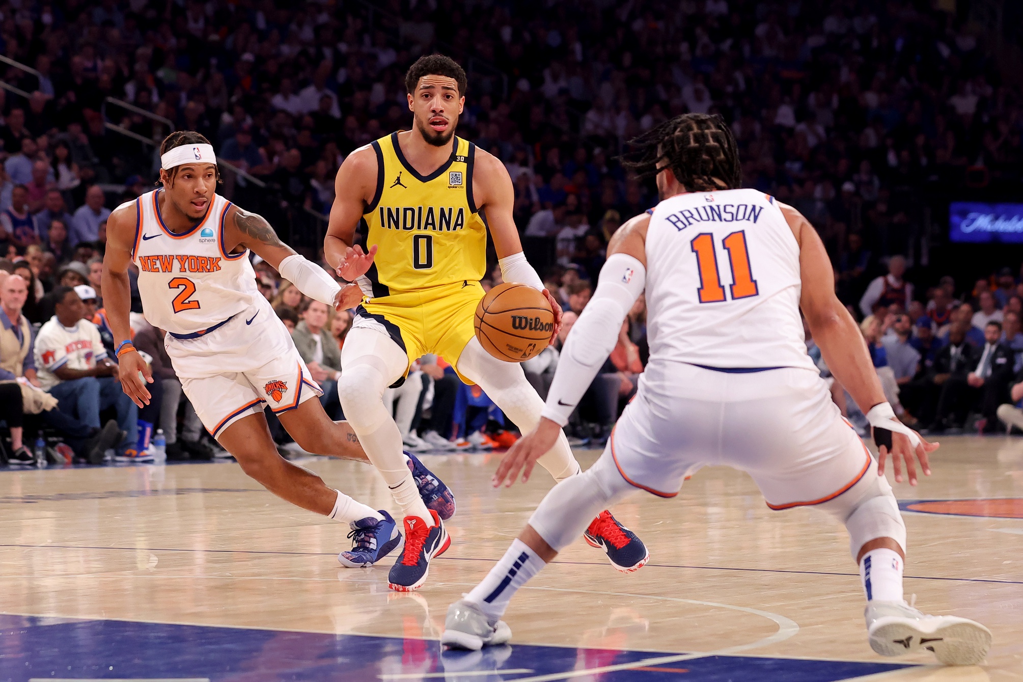 May 19, 2024; New York, New York, USA; Indiana Pacers guard Tyrese Haliburton (0) controls the ball against New York Knicks guards Miles McBride (2) and Jalen Brunson (11) during the first quarter of game seven of the second round of the 2024 NBA playoffs at Madison Square Garden. Mandatory Credit: Brad Penner-USA TODAY Sports