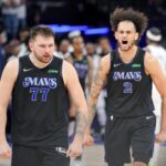 May 24, 2024; Minneapolis, Minnesota, USA; Dallas Mavericks guard Luka Doncic (77) and center Dereck Lively II (2) celebrate in the fourth quarter against the Minnesota Timberwolves in game two of the western conference finals for the 2024 NBA playoffs at Target Center. Mandatory Credit: Brad Rempel-USA TODAY Sports