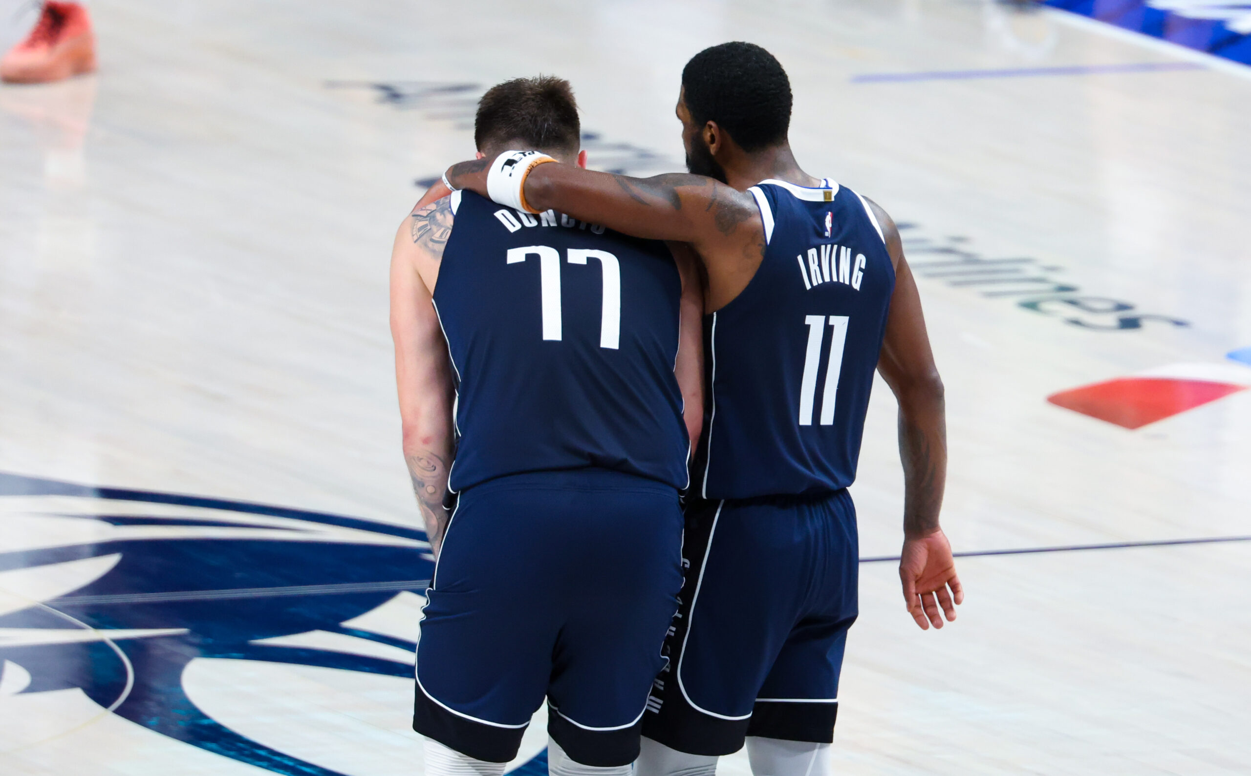 May 26, 2024; Dallas, Texas, USA; Dallas Mavericks guard Luka Doncic (77) and Dallas Mavericks guard Kyrie Irving (11) hug during the fourth quarter against the Minnesota Timberwolves during game three of the western conference finals for the 2024 NBA playoffs at American Airlines Center.